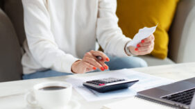 Business woman calculating balance prepare tax reduction income, Business woman hand using calculator to calculating balance prepare tax reduction income, cost budget expenses for pay money form personal Individual Income Tax Return in 2023 year. Deduction planning concept.